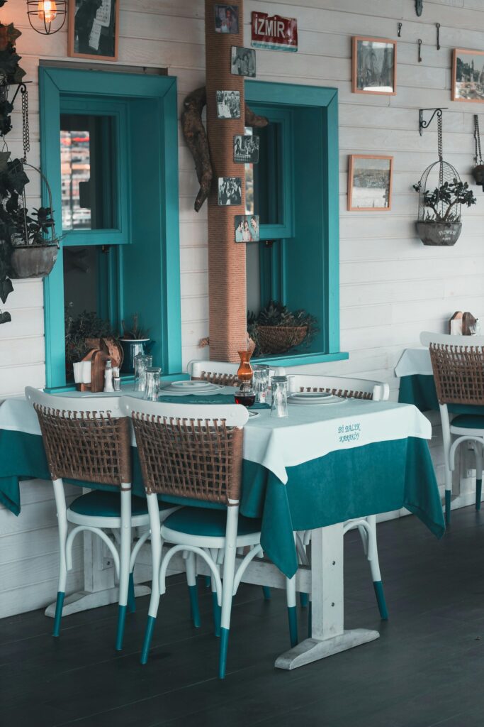 Cozy cafe setting in Istanbul featuring teal decor, wicker chairs, and a relaxed atmosphere.